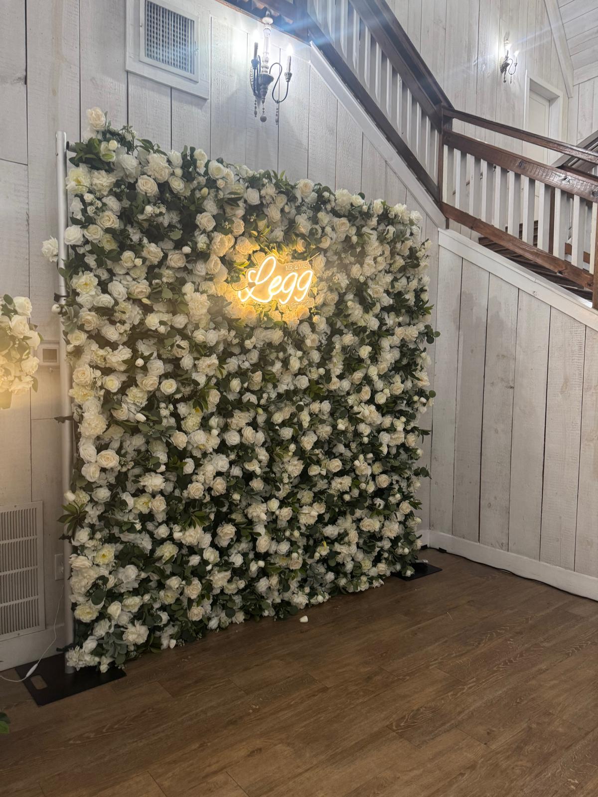 Flower wall with seating and tables